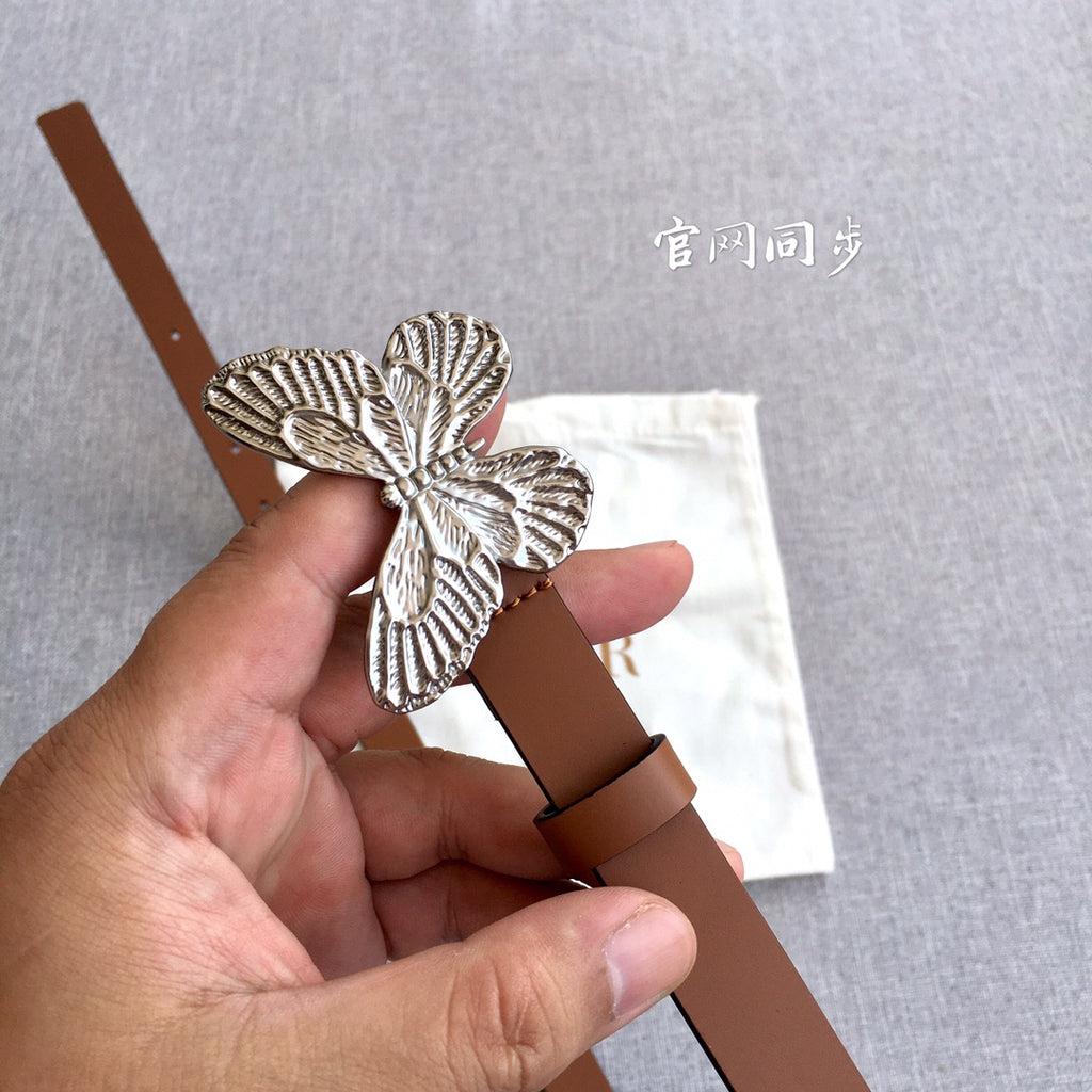 Silver butterfly buckle on a brown leather belt with adjustable strap holes