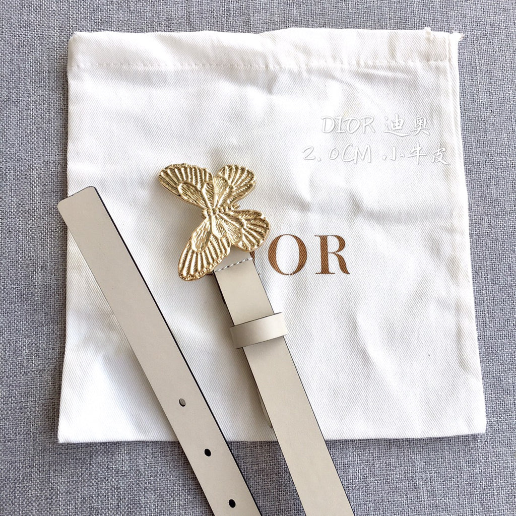 Light beige belt with gold butterfly buckle, pin closure, and eyelet holes