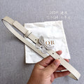 Cream leather belt with silver butterfly buckle and punched holes