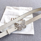 Cream leather belt with silver butterfly buckle and punched holes, top view