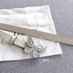 Cream leather belt with silver butterfly buckle and punched holes, angled view