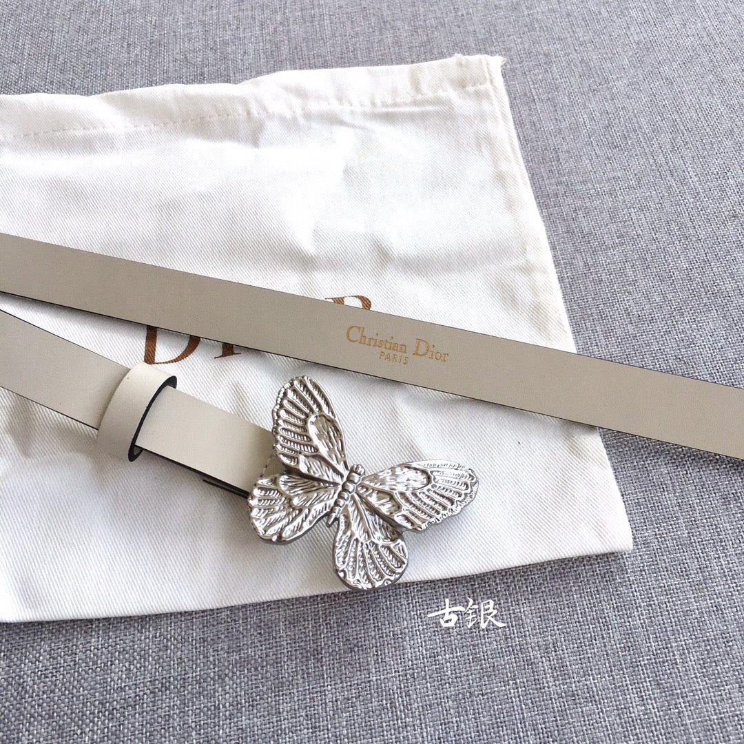 Cream leather belt with silver butterfly buckle and punched holes, angled view