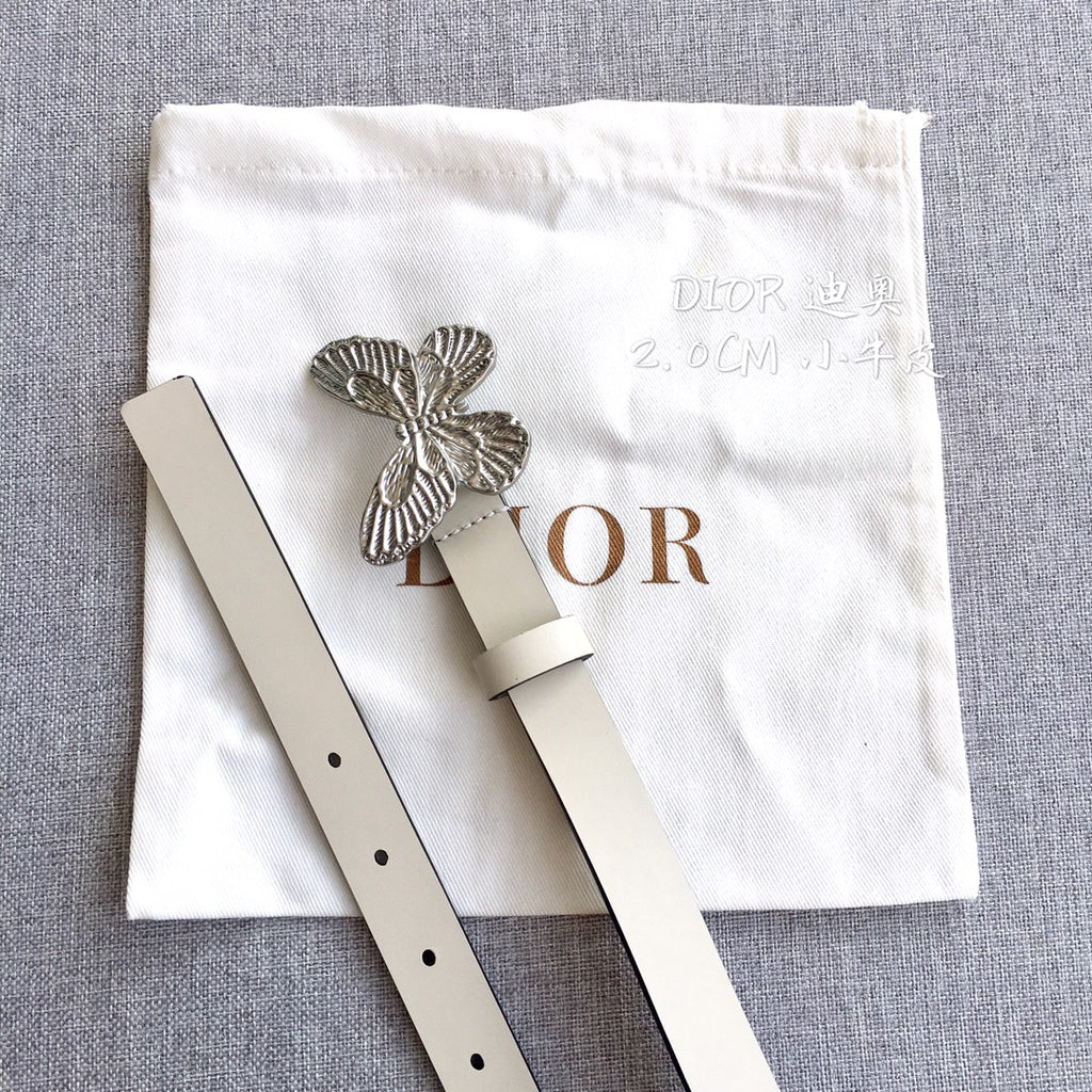Cream leather belt with silver butterfly buckle and punched holes, side view