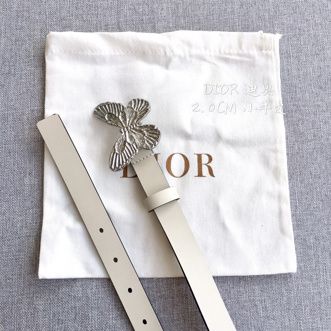 Cream leather belt with silver butterfly buckle and punched holes, side view