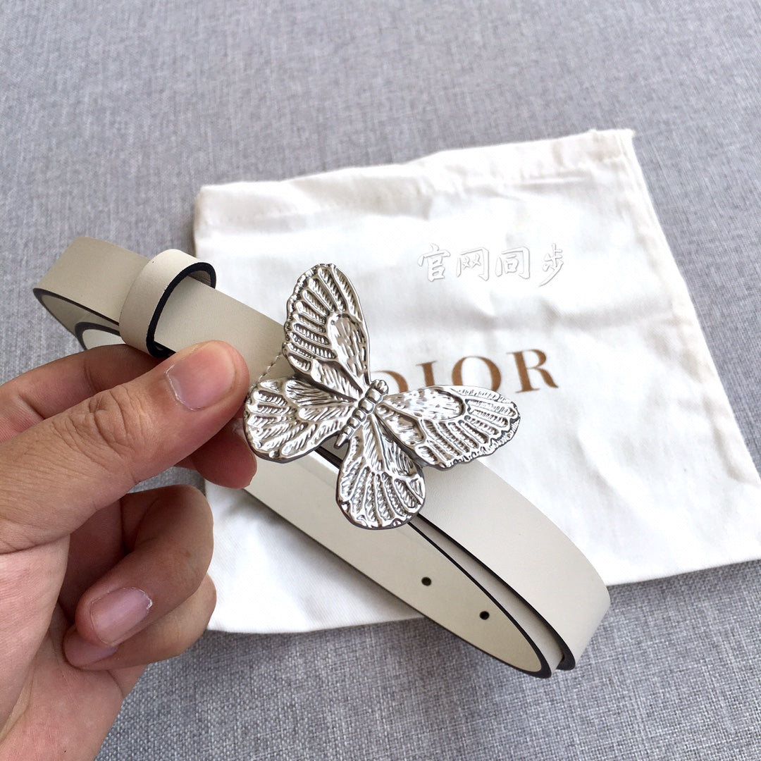 Cream leather belt with silver butterfly buckle and punched holes, hand holding end
