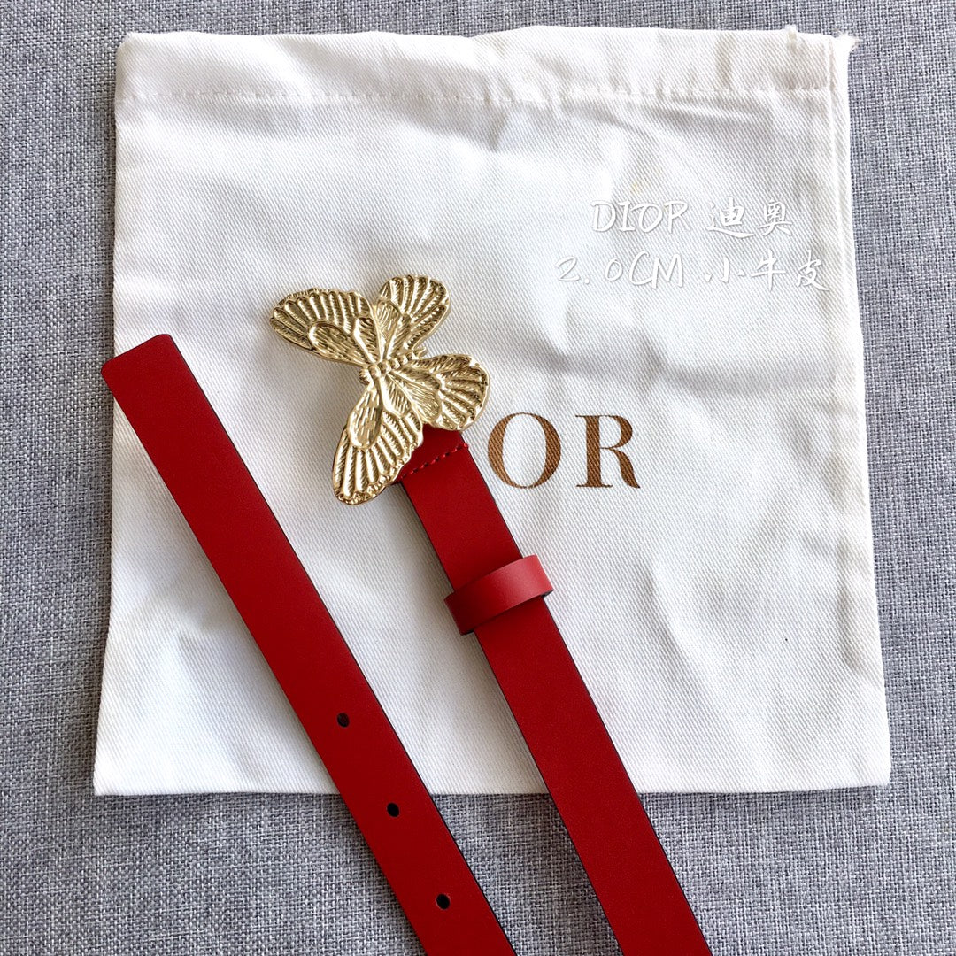 Red leather belt with gold-tone butterfly emblem and punched adjustment holes.