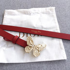 Red leather belt with gold-tone butterfly buckle and a red buckle keeper strap.