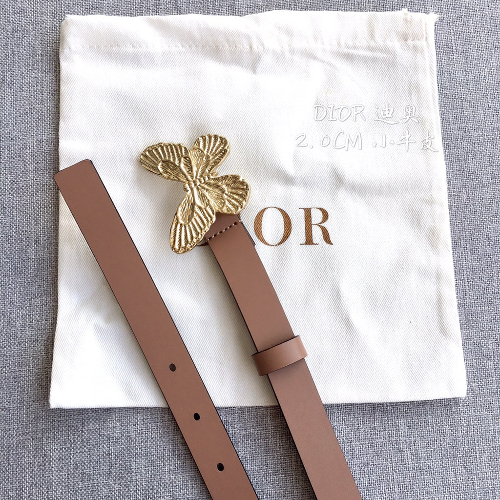 Dior belt flat lay: brown strap with gold butterfly buckle and end tabs