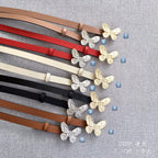 Assorted Dior belts with butterfly buckles in multiple colors, labeled with number markers.