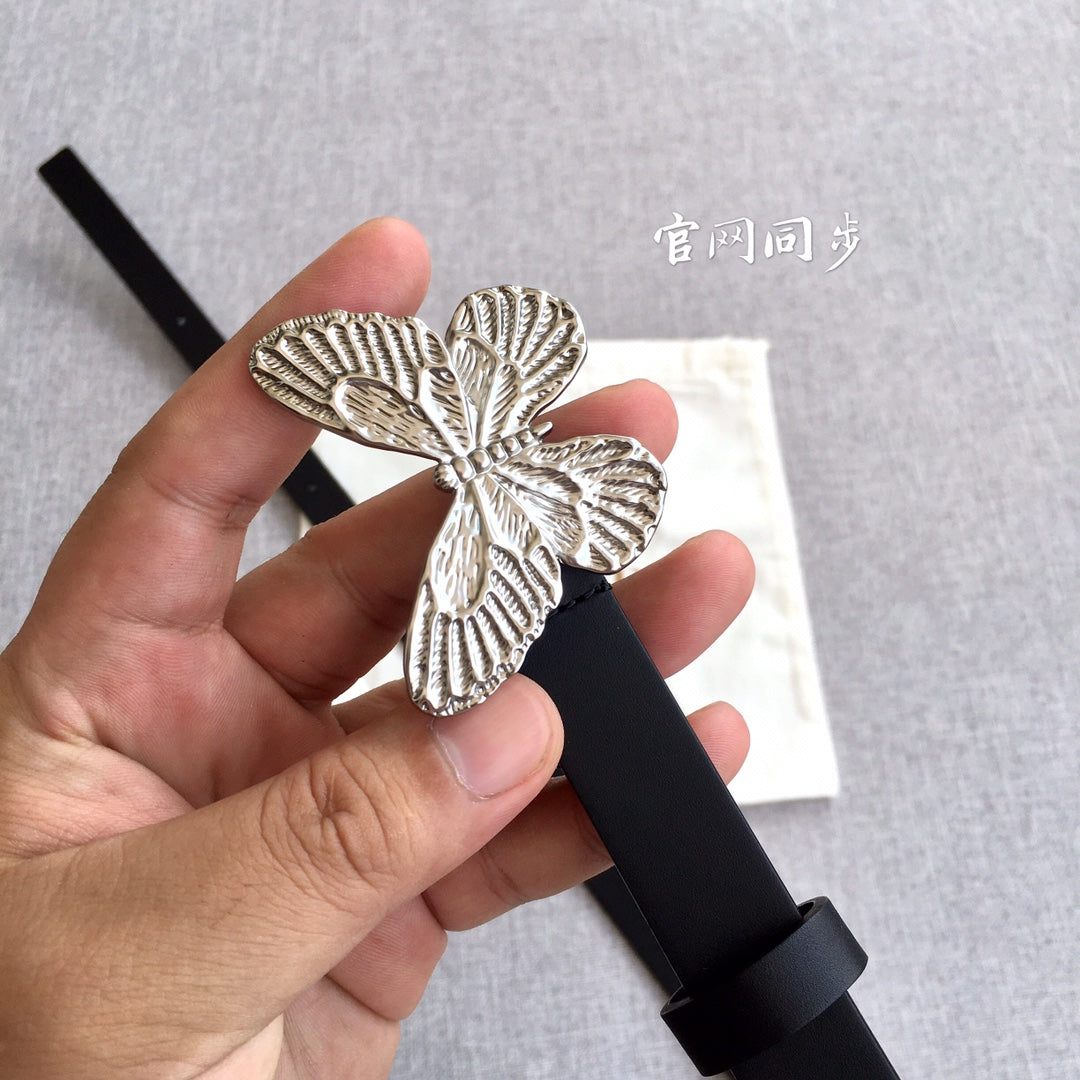 Dior black leather belt held in hand, silver-tone butterfly buckle