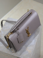 YSL bag side view with chain strap, stitched trim, and front logo charm, gray-lavender