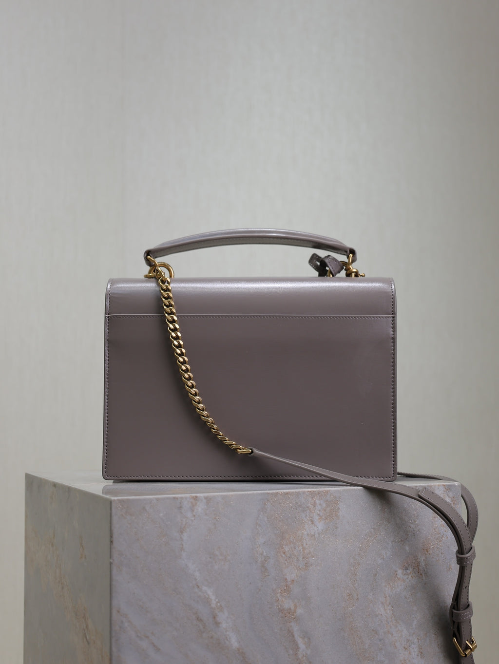 YSL bag front view with chain strap and top handle, rectangular silhouette, gray-lavender