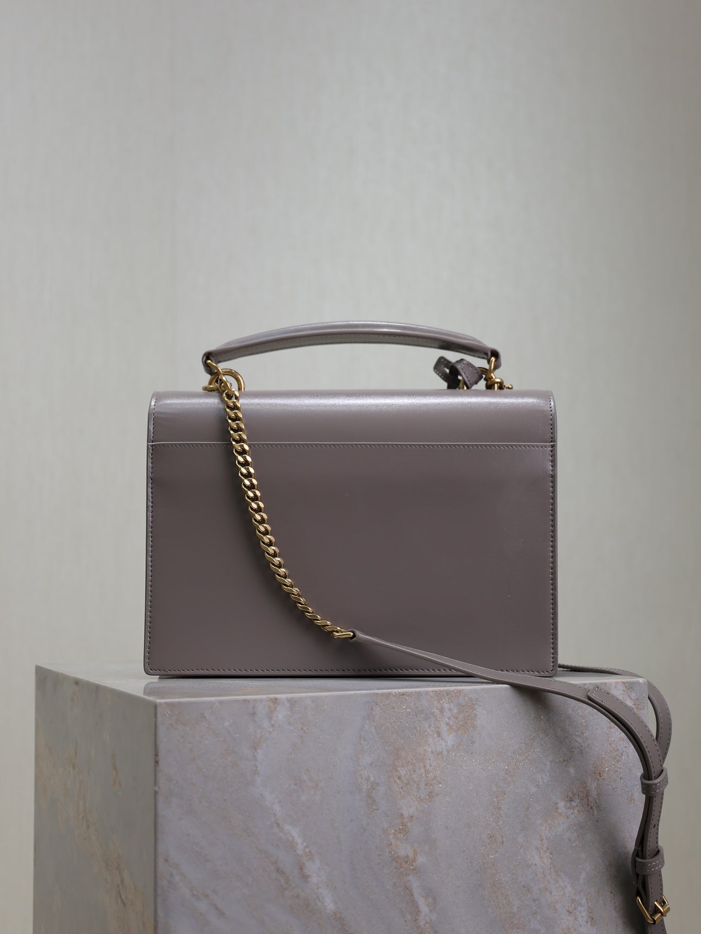 YSL bag front view with chain strap and top handle, rectangular silhouette, gray-lavender