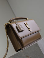 YSL tan small top-handle bag with chain strap, flap closure, and YSL logo