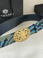 Versace belt close-up: gold-tone oval buckle on blue-green patterned strap with prong