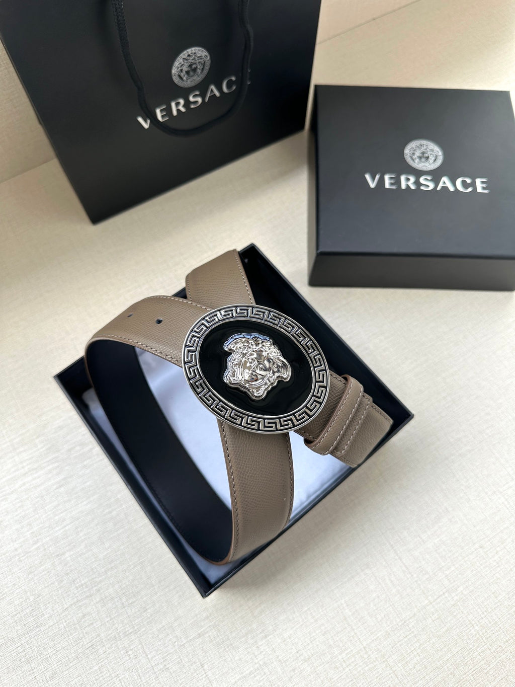 Leather belt with oval Greca Medusa buckle in silver tone and light taupe strap