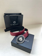 Versace maroon belt with gold Medusa buckle, shown with folded strap on box