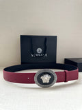 Versace belt with maroon leather strap and gold Medusa buckle with Greek key border