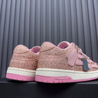 Amiri pink sequin sneakers showing heel and back, with AMIRI logo on the sole