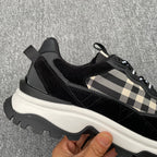 Black low-top sneakers with beige check strap detail and thick white sole