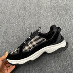 Black chunky sneakers with beige check accents and lace-up front