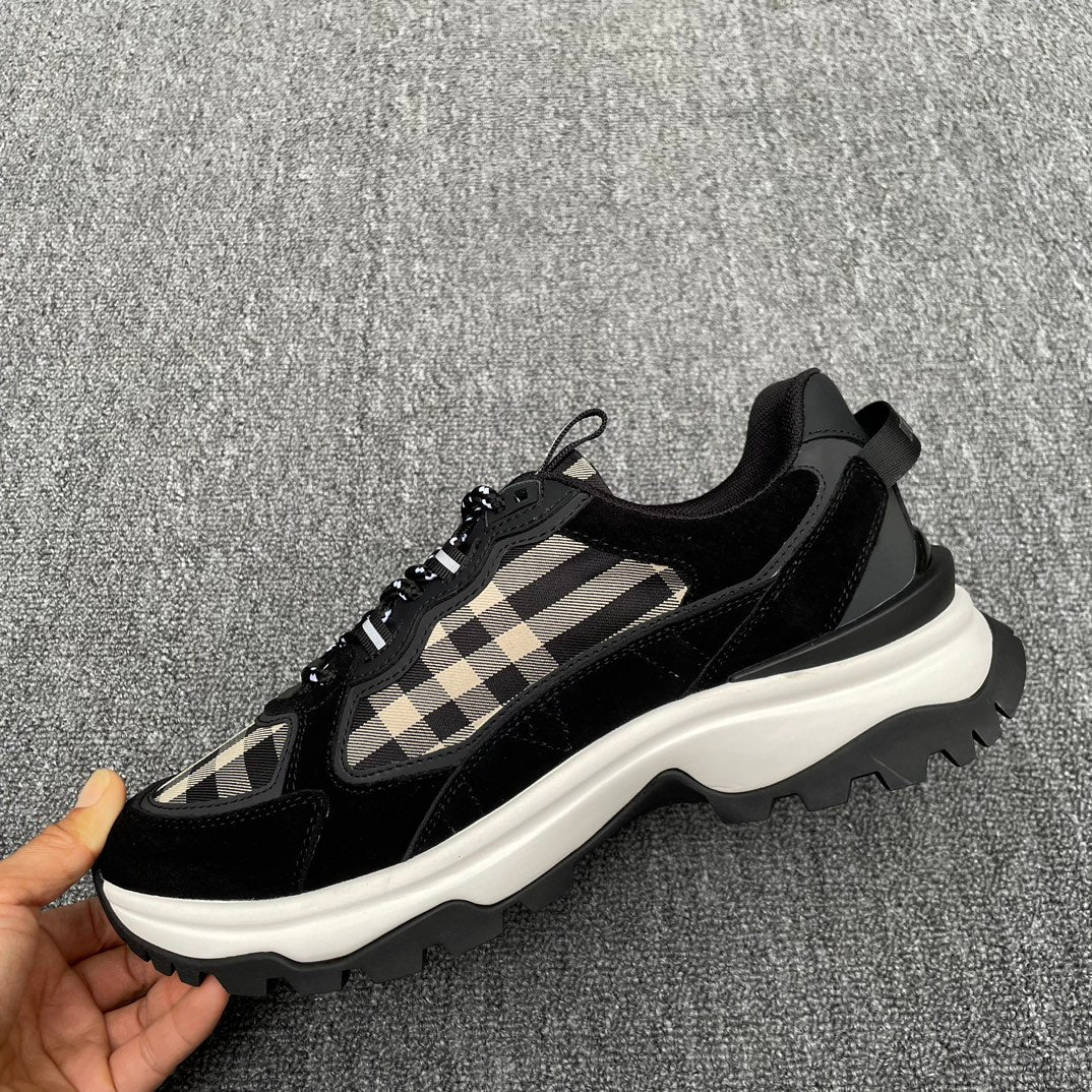 Black chunky sneakers with beige check accents and lace-up front