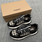Black sneakers with beige check panels, lace-up front, and white rubber sole