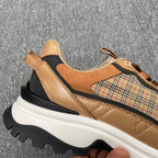 Burberry sneakers close-up, tan leather with plaid patch and quilted panel