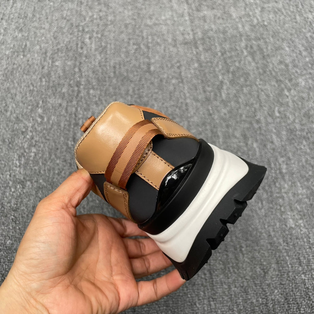 Burberry sneaker heel view, tan upper with striped webbing and chunky white sole