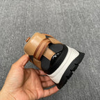 Burberry sneaker heel view, tan upper with striped webbing and chunky white sole