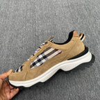 Hand-held tan suede sneaker with Burberry check panel and white-and-black sole