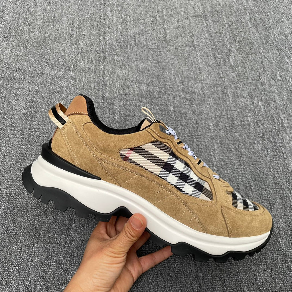 Tan suede sneakers with Burberry check detail, black heel accent, and thick sole