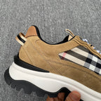 Side view of tan suede sneakers with Burberry check overlays and white midsole