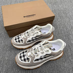 Gray low-top sneakers with black-and-white check panel, white laces, chunky gum sole
