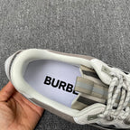 Gray sneaker interior with Burberry logo patch, laces and plaid trim