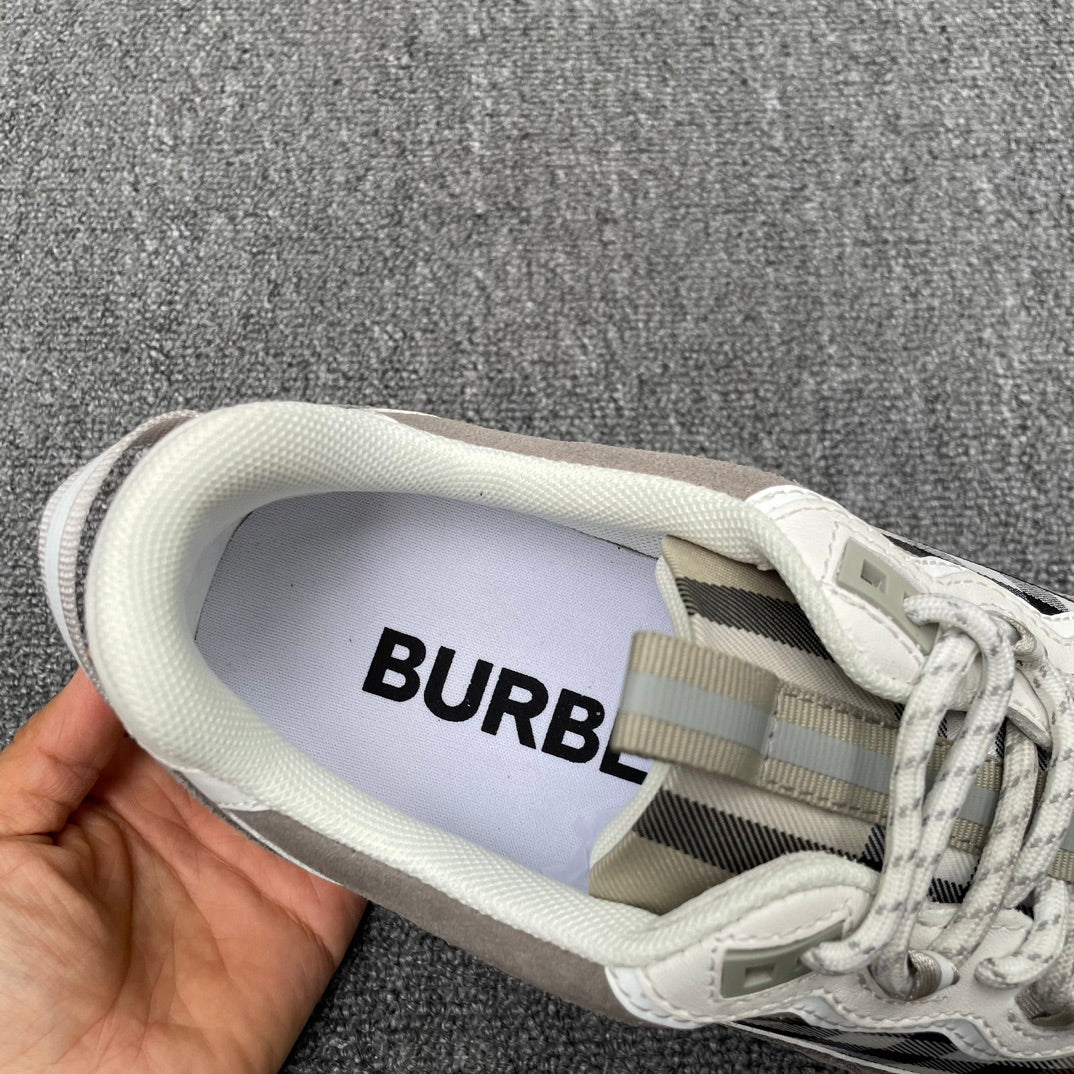 Gray sneaker interior with Burberry logo patch, laces and plaid trim