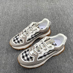 Gray low-top sneakers with checkered side panels, white laces, thick sole