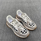 Gray low-top sneakers with black-and-white check side panels and white laces