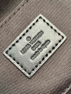 Louis Vuitton bag interior label on gray fabric with stitched tag and 'Made in Spain'