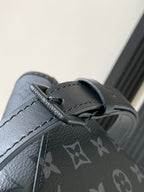 Louis Vuitton bag strap close-up with gray leather trim and monogram fabric