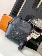 Louis Vuitton bag with gray monogram print, front zipper pocket, and snap button