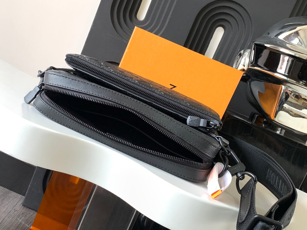 Louis Vuitton crossbody bag, dark gray with double zip closures and smooth trim