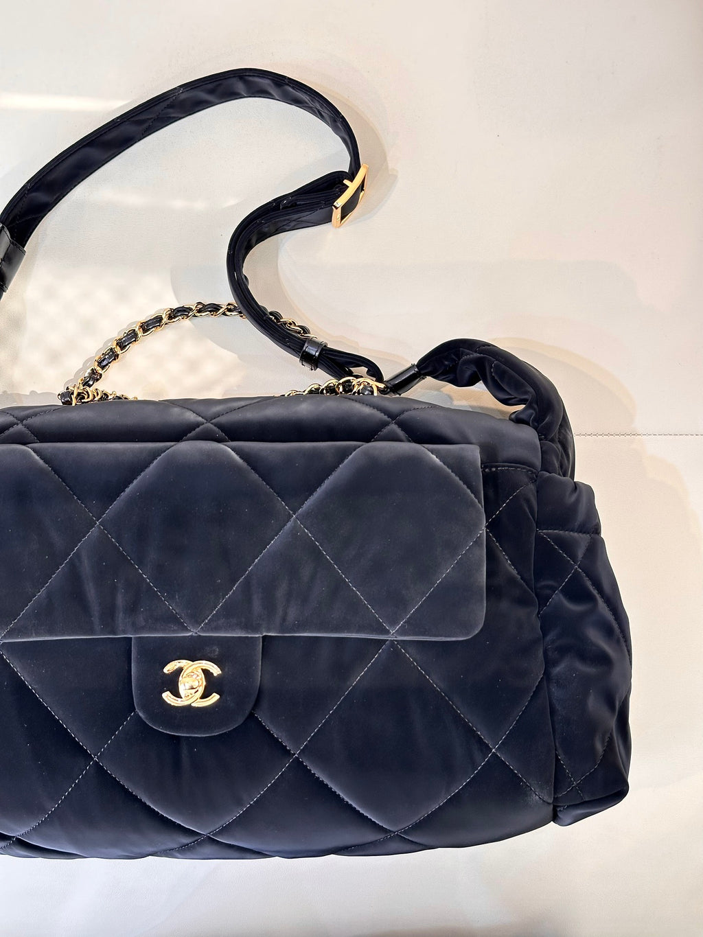 Chanel quilted shoulder bag with flap, gold chain strap, and CC emblem in dark navy