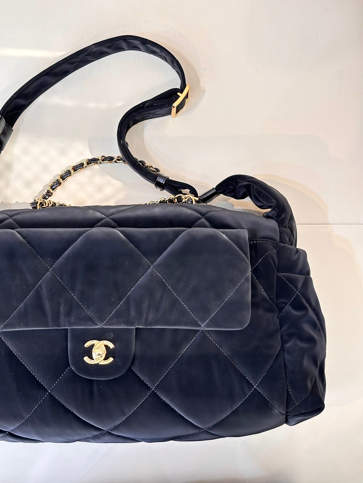 Chanel quilted shoulder bag with flap, gold chain strap, and CC emblem in dark navy