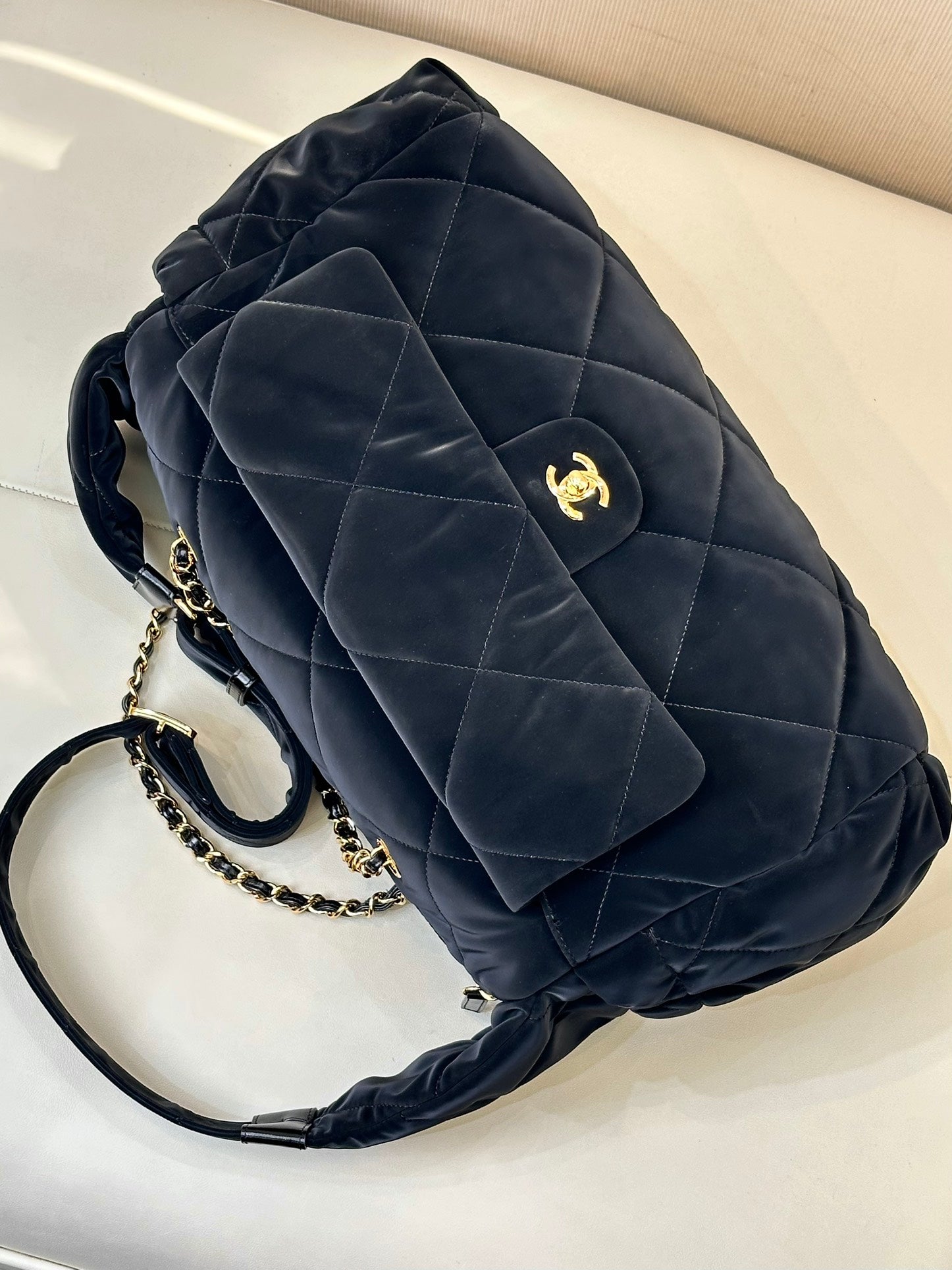 Chanel quilted shoulder bag in dark navy with pocket flap, gold chain and logo