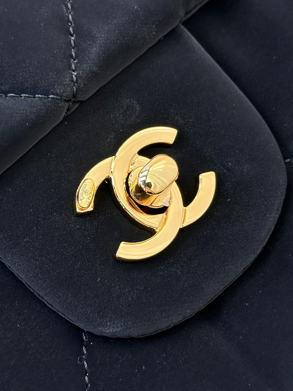 Chanel gold CC emblem on dark navy quilted flap