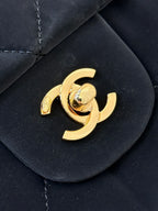 Chanel gold CC emblem on dark navy quilted flap