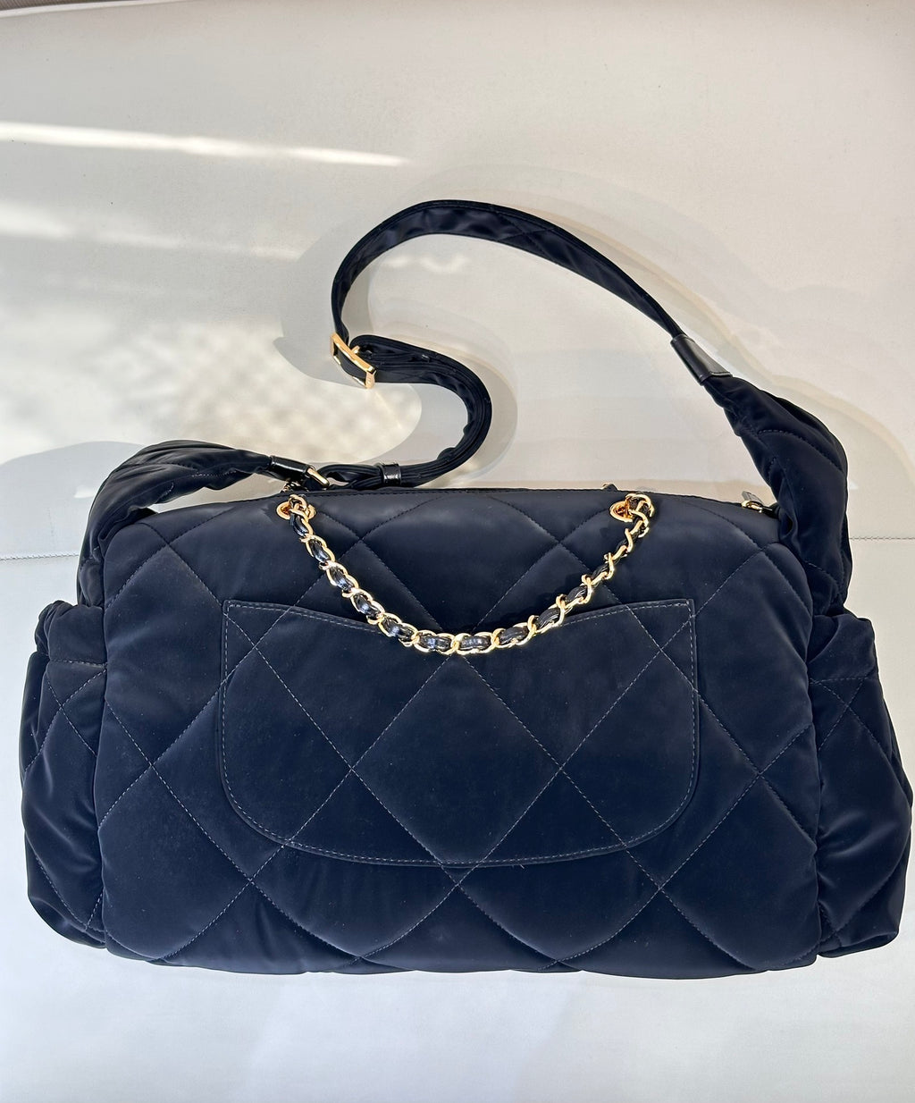 Chanel quilted shoulder bag in dark navy with gold chain handle and flap