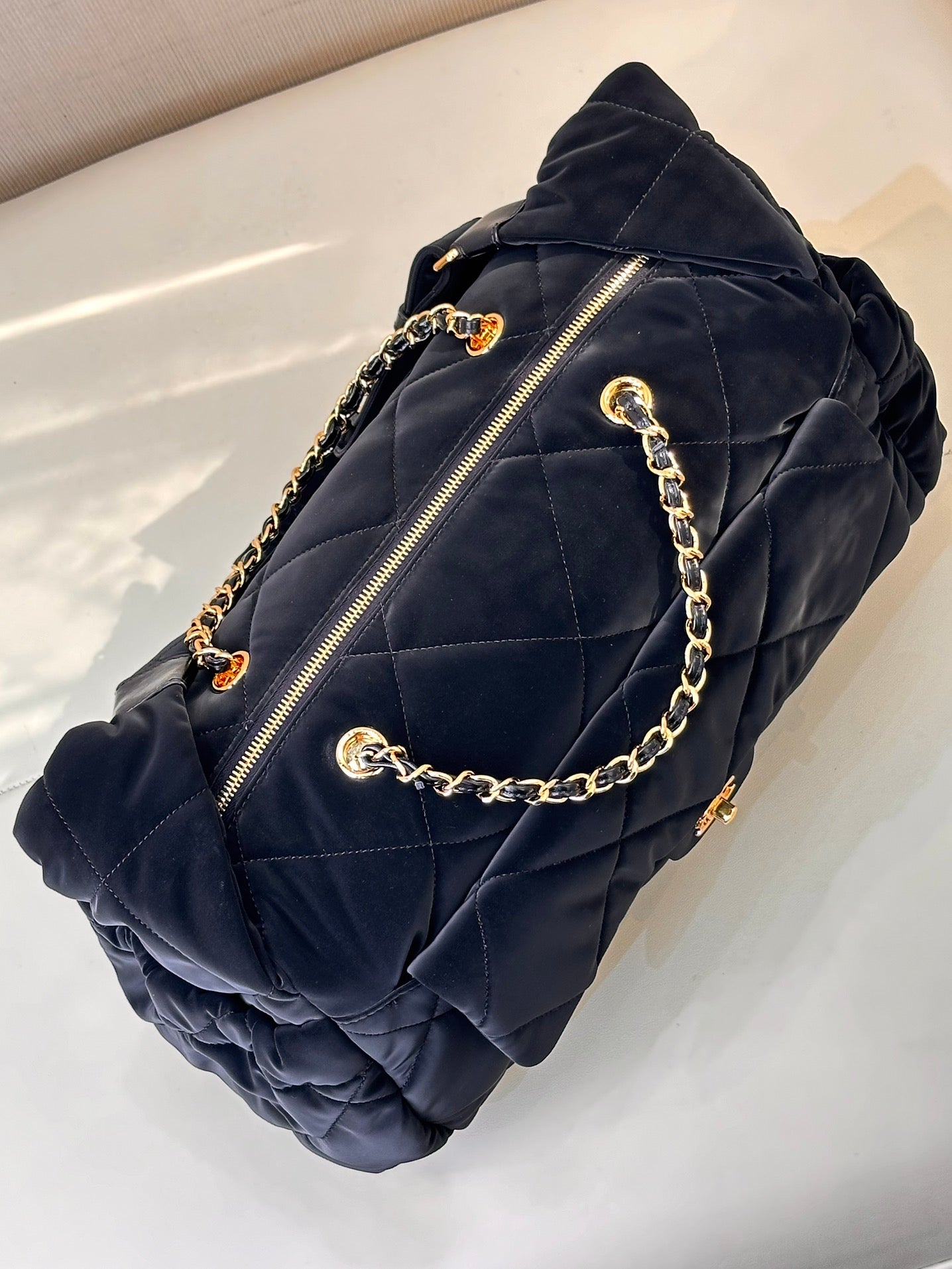 Chanel quilted shoulder bag in dark navy with zip pocket and gold chain strap