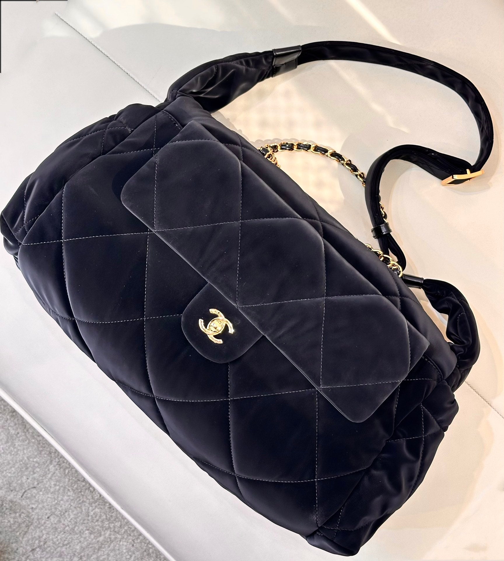 Chanel quilted shoulder bag in dark navy with curved flap and gold CC emblem